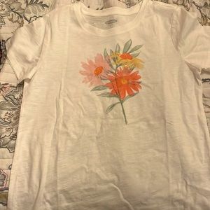 White shirt with flower on it. Super nice and comfy.